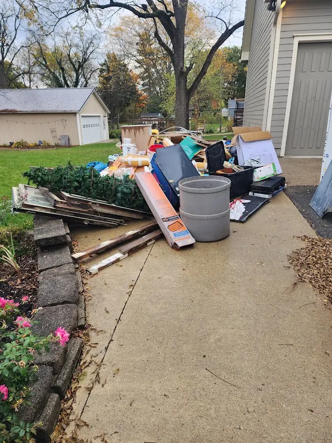 Dumpster being loaded with debris for 12 Yard Dumpster Rental in Moss Bluff